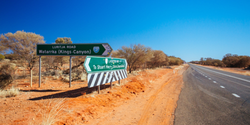 Road sign directing towards Uluru and Kings Canyon in NT - Australian Stock Image