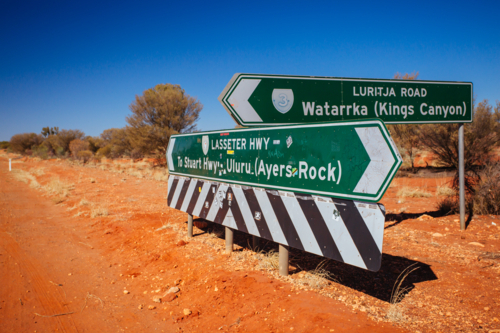 Road sign directing towards Uluru and Kings Canyon, NT - Australian Stock Image