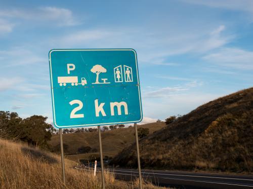 Road sign showing parking, rest area and toilets ahead - Australian Stock Image