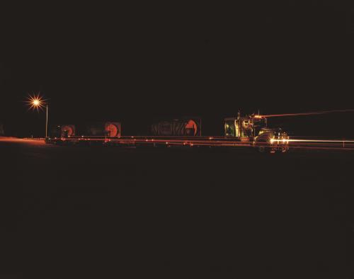 Road train at night with light trails