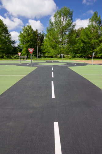 Roads, roundabout and give way sign at children’s play park - Australian Stock Image