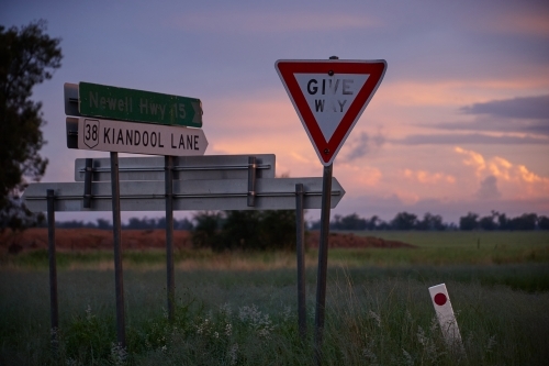 Roadside signage in rural area on sunset - Australian Stock Image
