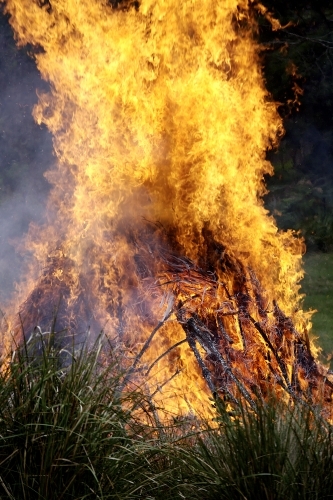 Roaring bonfire at a farm during the day - Australian Stock Image