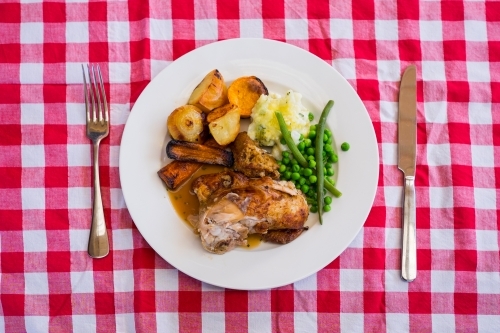 Roast chicken dinner on checkered tablecloth