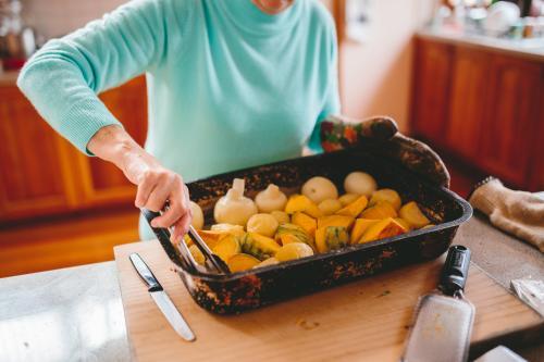 Roast vegetables being served - Australian Stock Image