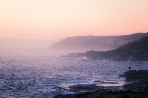Rock fishing at sunrise - Australian Stock Image