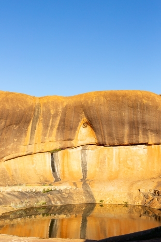 Rock pool and wave formation at Beringbooding Rock - Australian Stock Image