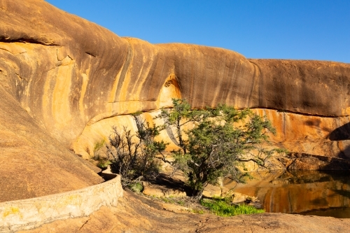 Rock pool and wave formation at Beringbooding Rock - Australian Stock Image