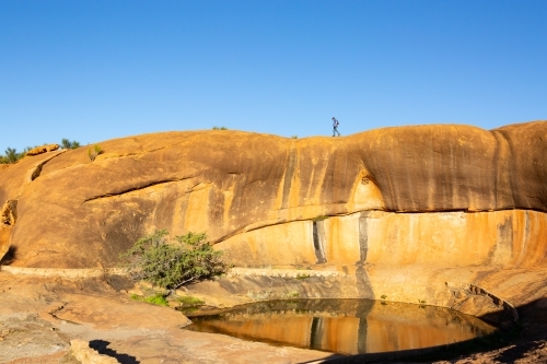 Rock pool and wave formation at Beringbooding Rock - Australian Stock Image