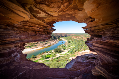 Rock window framing a winding river and rugged valley - Australian Stock Image