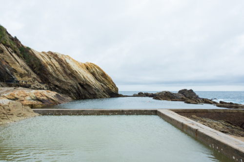 Rocks and ocean pool in Bermagui - Australian Stock Image
