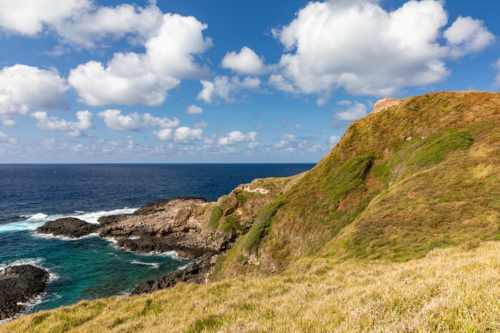 Rocky coastline with blue sky and white clouds - Australian Stock Image