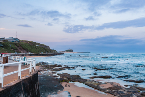 Rocky ocean view along the coast at dusk in Newcastle NSW Australia - Australian Stock Image