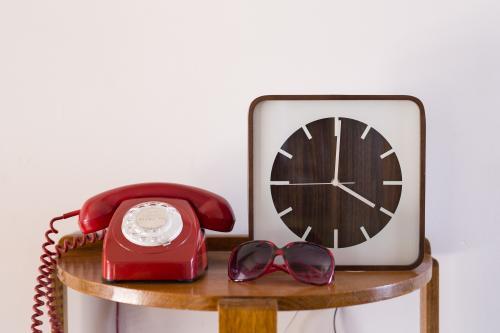Rotary dial telephone and clock on display