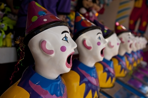 Row of clown heads, turning away