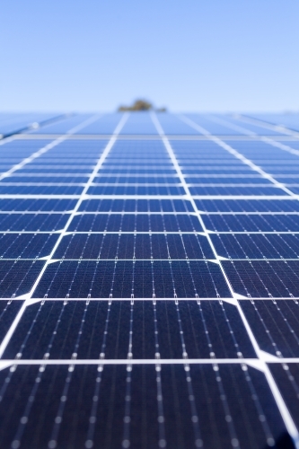 Rows of blue solar panels up to sky on roof of home - Australian Stock Image