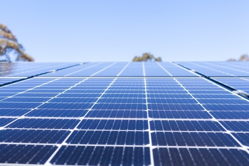 Rows of blue solar panels up to sky on roof of home - Australian Stock Image