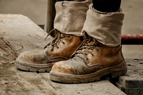 Rugged pair of brown tradesman's workboots on building site