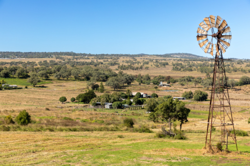 Rural landscape with rusted windmill - Australian Stock Image