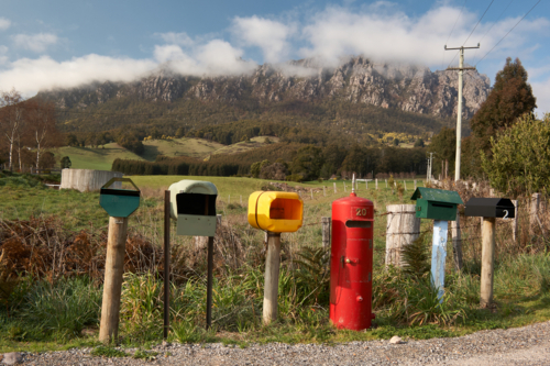 Rural letterboxes in front of cloudy mountain. - Australian Stock Image