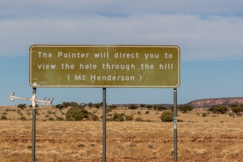 Rural road sign with a pointer directing to a view of a hole in a hill. - Australian Stock Image