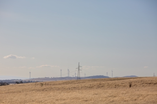 Rural Wind Turbines in a farm setting with Energy wires - Australian Stock Image