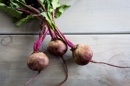 Rustic beetroots on a grey wood table - Australian Stock Image