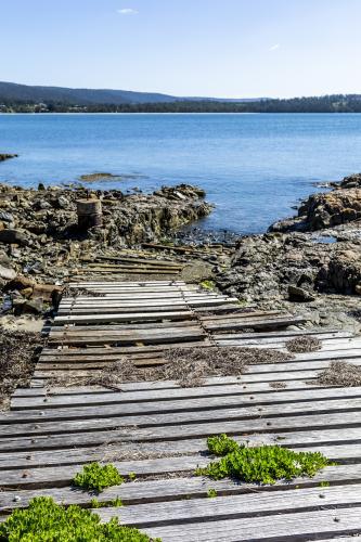 Rustic slipway on a rocky coast - Australian Stock Image