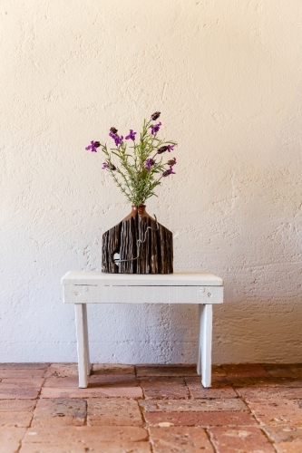 rustic vase of lavender on white stool - Australian Stock Image