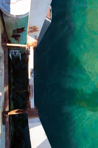 Rusty ladder entering the ocean - Australian Stock Image