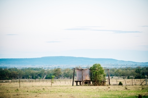 Rusty tank amongst a scenic rural landscape - Australian Stock Image