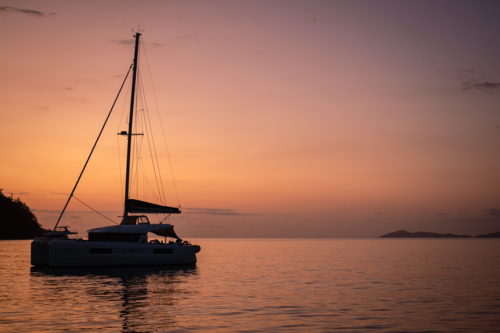 sailing boat in calm water near islands - Australian Stock Image