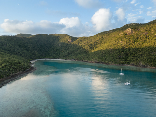 sailing boats in calm water near islands - Australian Stock Image