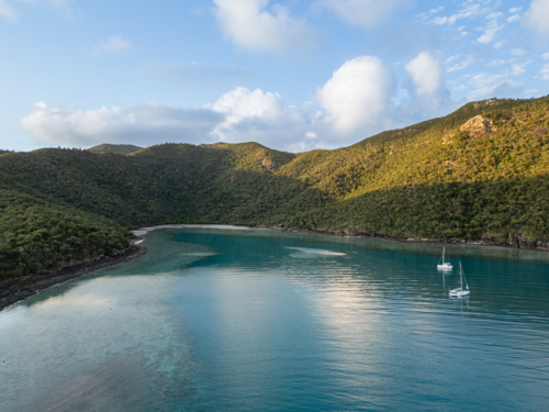 sailing boats in calm water near islands - Australian Stock Image