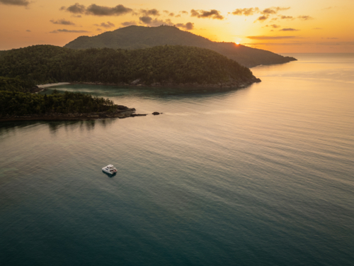sailing boats in calm water near islands - Australian Stock Image