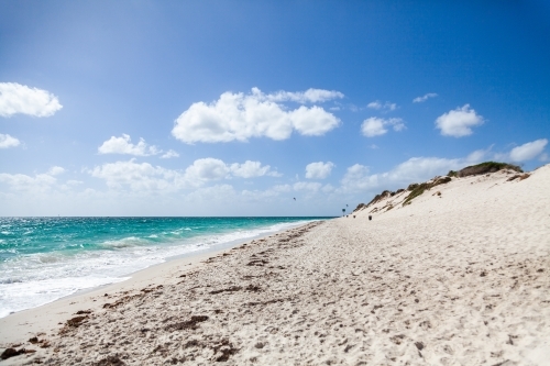 Sand dunes and beach with kitesurfing people in the distance - Australian Stock Image