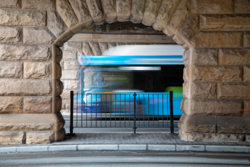 Sandstone arches under bridge with motion blur vehicles - Australian Stock Image