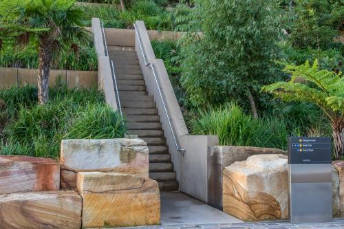 Sandstone blocks and stairs surrounded by garden at Barangaroo - Australian Stock Image