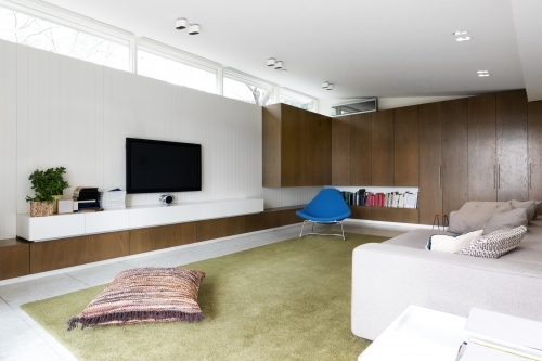 Scandinavian styled contemporary living room with walnut built in cabinets - Australian Stock Image
