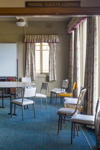 Scattered chairs in empty chalet room - Australian Stock Image