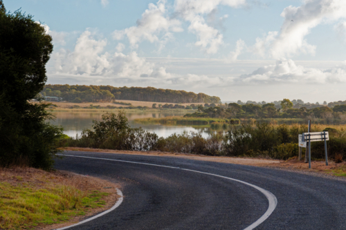 Scenic Drive on a Winding Road Beside the water at Clayton Bay - Australian Stock Image