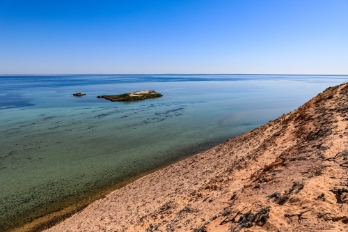 Scenic ocean along arid coastline and blue sky - Australian Stock Image