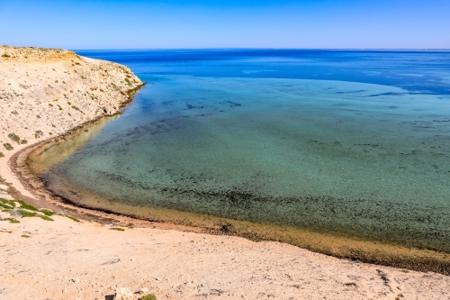 Scenic ocean along arid coastline and blue sky - Australian Stock Image
