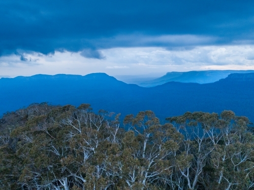 Scenic view of tree covered landscape in blue mountains with approaching storm - Australian Stock Image