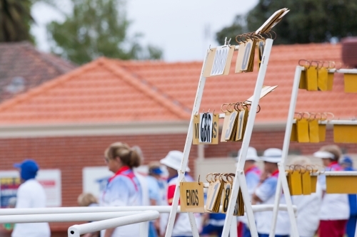 Scoreboard and bowlers at a lawn bowls club - Australian Stock Image