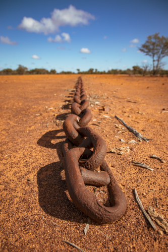 Scrub pulling chain lying on the ground - Australian Stock Image