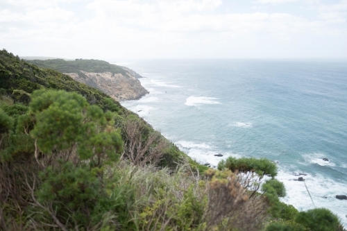 Sea cliffs slope down to ocean along Victorian coast - Australian Stock Image