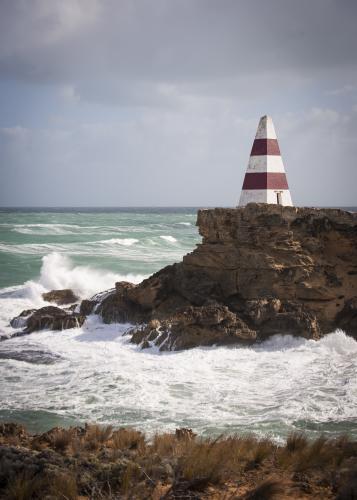 Seaside obelisk perched on the rocks at Cape Dombey - Australian Stock Image