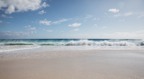 Seaward view of empty beach in the morning - Australian Stock Image