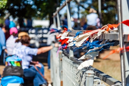 Selective focus on bunting flags on arena rails at rural country show
